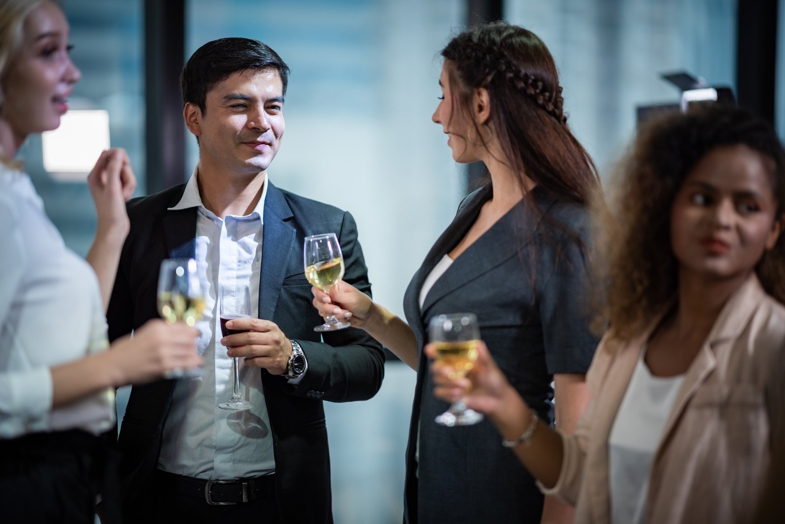 A group of business people holding a glass of champagne in a party to celebrate their success